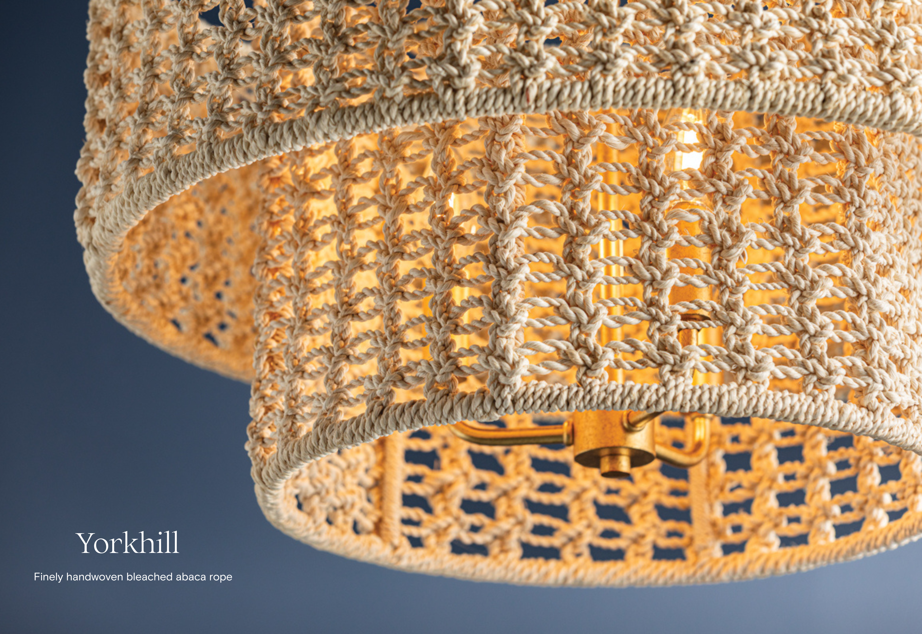 Finely handwoven from bleached abaca rope, the Yorkhill by Hudson Vallet Lighting channels bohemian style with its macramé-like design