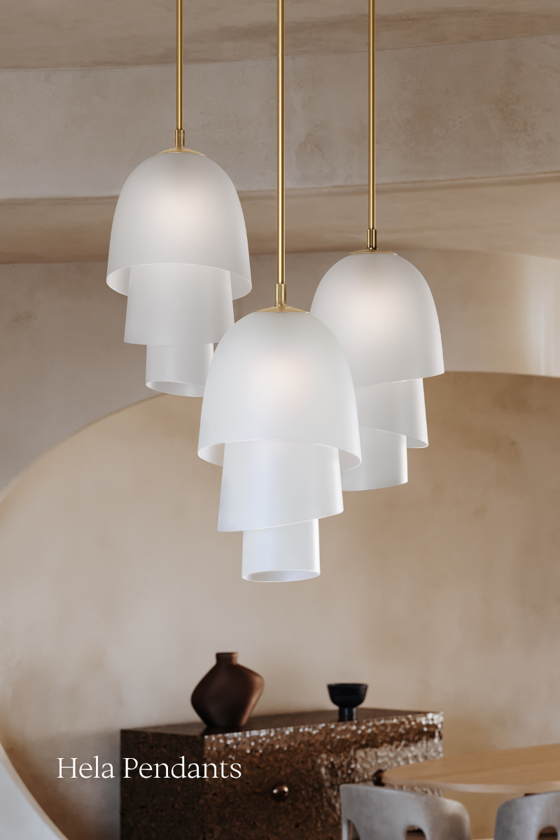Three modern Hela pendants by Corbett Lighting in an open concept living room