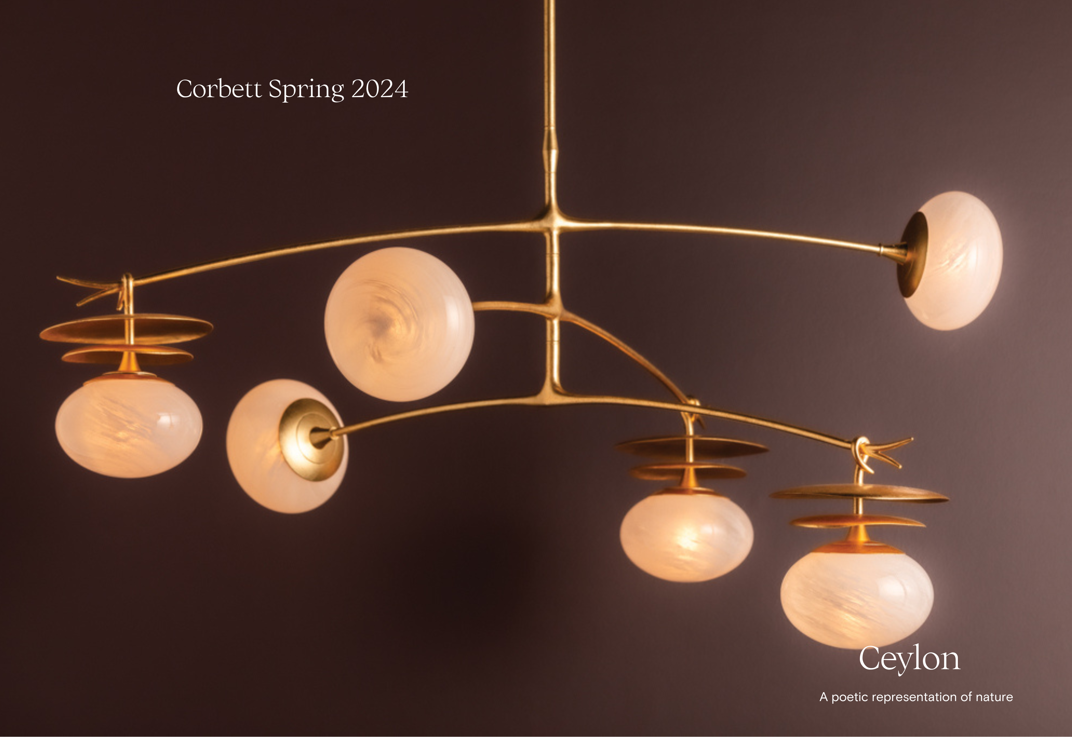 Large gold Ceylon chandelier with round globes and gold discs on a purple backdrop by Corbett Lighting
